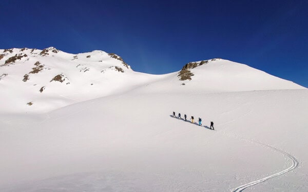 Sunny ascent with skis