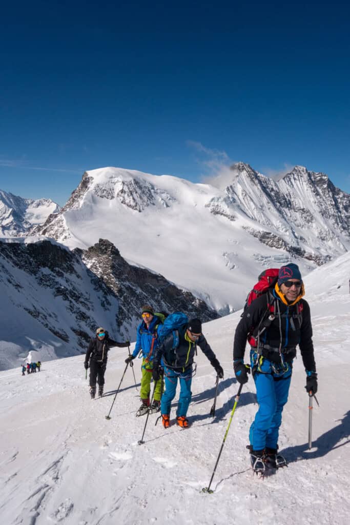 Ski tourers ascending the Allalinhorn, the Alphubel in the background