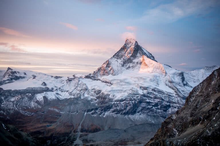 Beautiful picture of the Matterhorn at dawn with a small cloud. View from the Arbenbiwak. Landscape format.