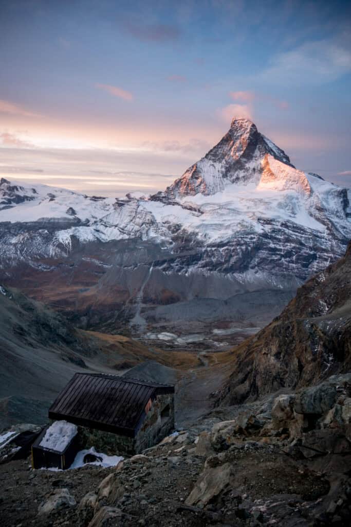 Beautiful picture of the Matterhorn at dawn with a small cloud. View from the Arbenbiwak. Portrait format.